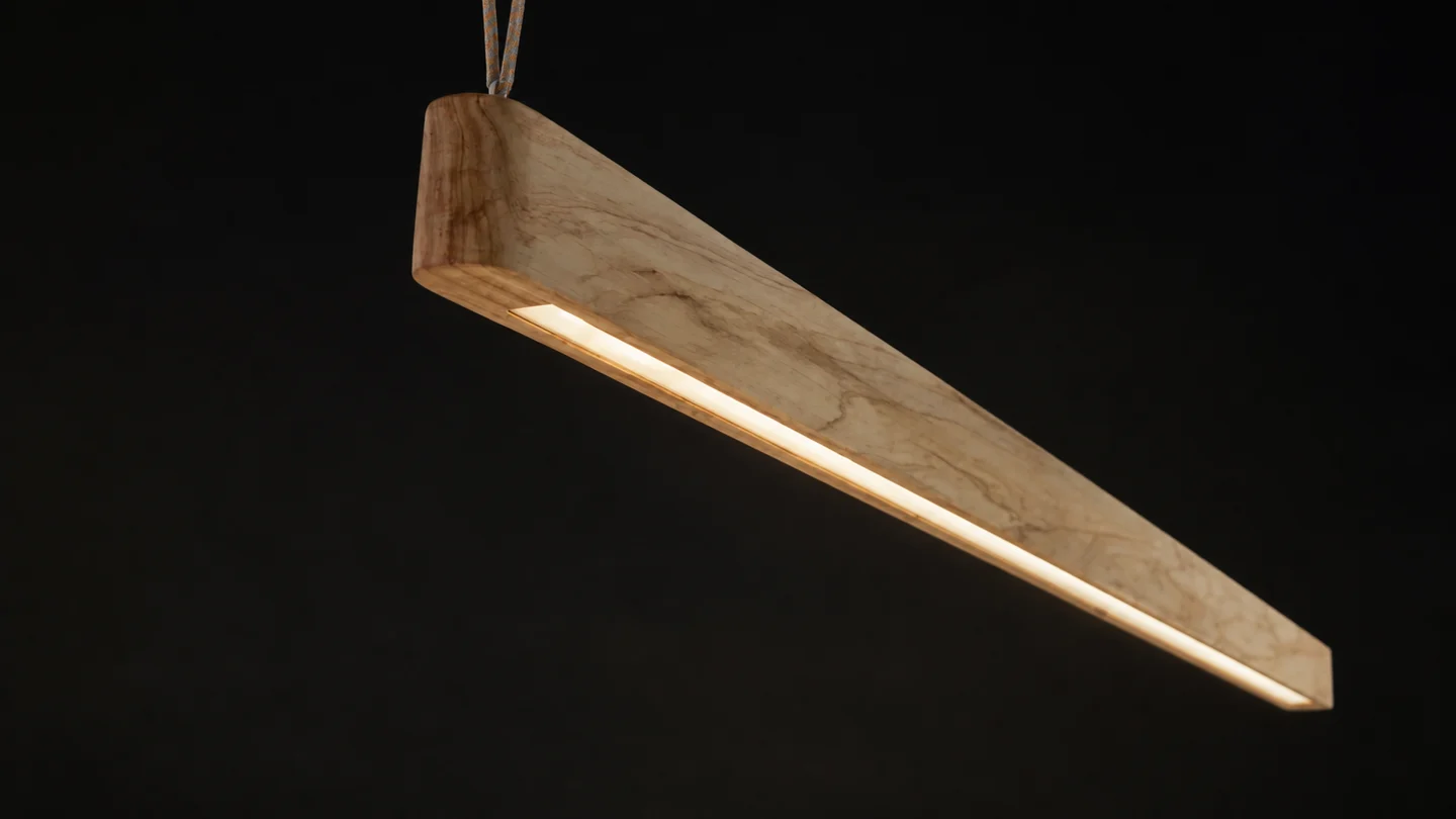 Timber pendant illuminated against a dark background